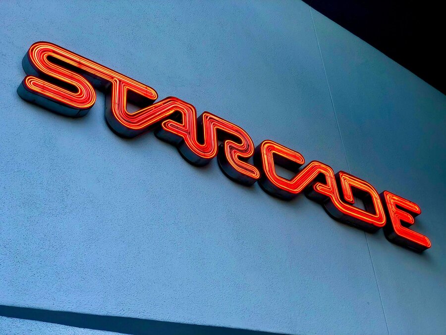 Starcade neon sign glowing in Tomorrowland