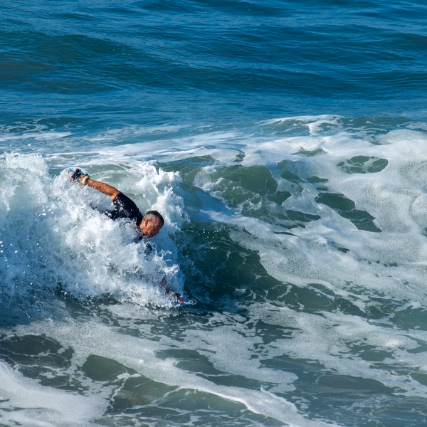 Man surfing the face of a wave