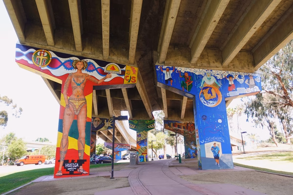 Wide shot of murals at Chicano Park on the pillars of a freeway overpass