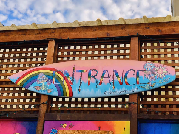 Painted surfboard with the word Entrance in large letters