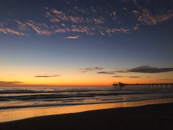 Scripps pier at dusk with sunset colors behind it
